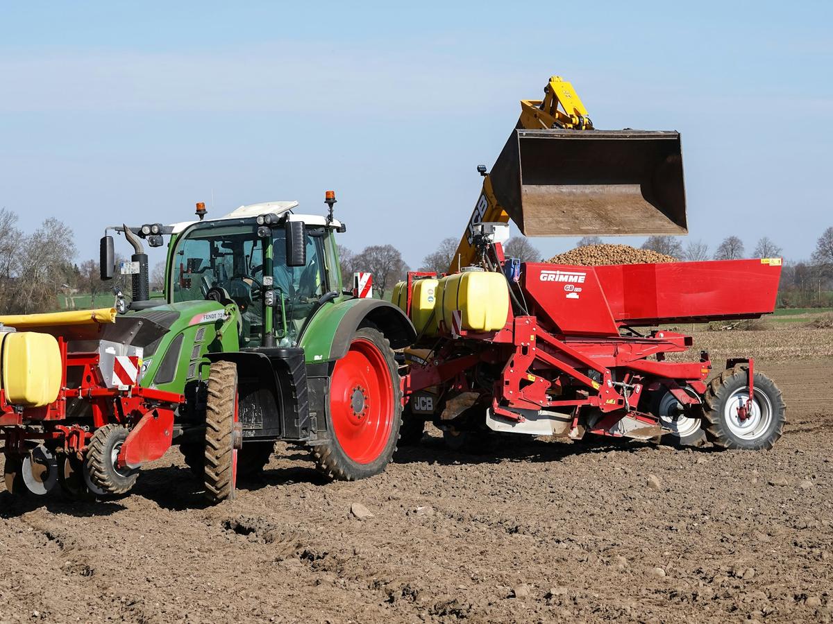 Traktor mit Kartoffellegemaschine auf dem Acker